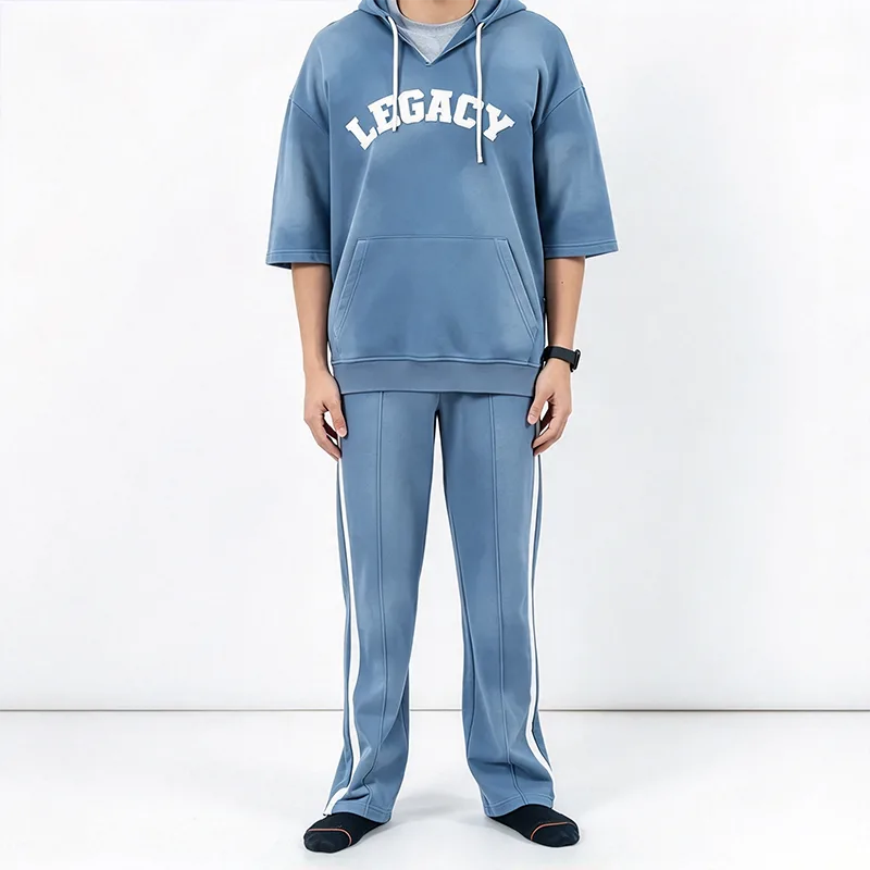 Tuta blu con cappuccio a maniche corte e pantaloni bianchi con strisce laterali Tuta blu con cappuccio a maniche corte e pantaloni bianchi con strisce laterali